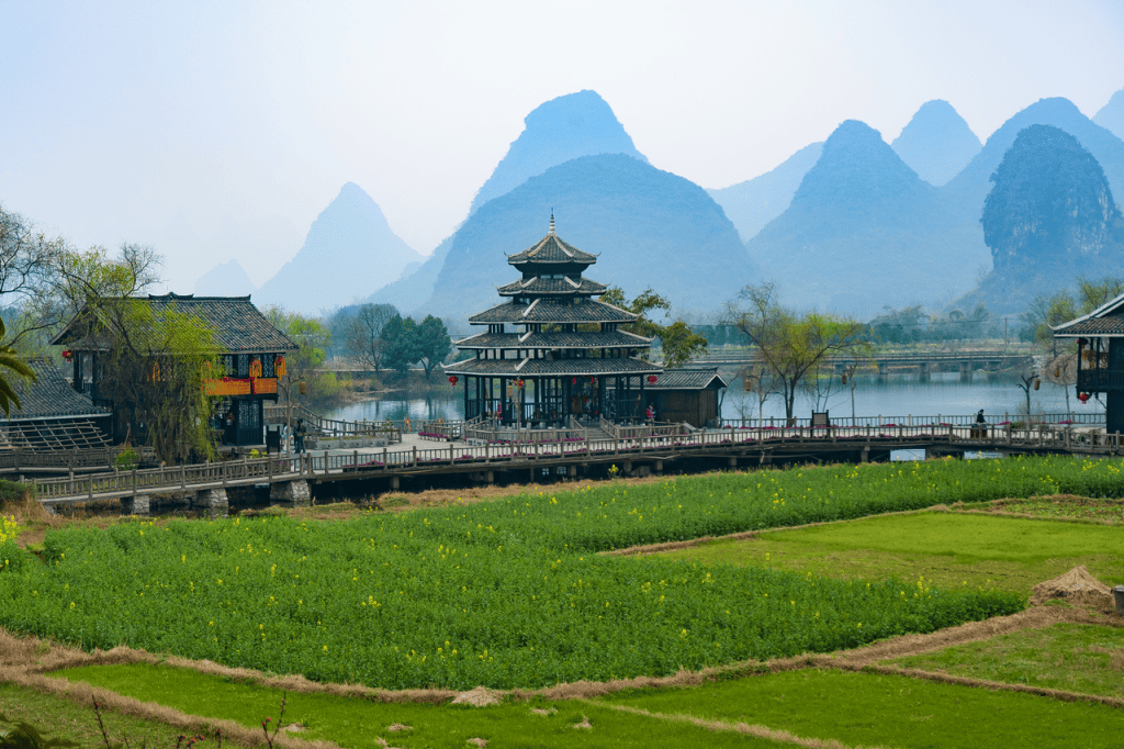 Picturesque view of traditional Chinese architecture and mountains in Guilin, China.
